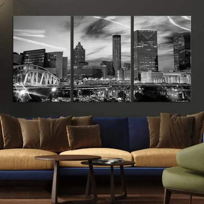 A modern living room featuring the Black and White Atlanta Wall Art Canvas Print as a triptych, displayed on museum-quality canvas and ready to hang.