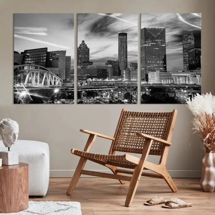 A modern living room featuring the Black and White Atlanta Wall Art Canvas Print as a triptych, displayed on museum-quality canvas and ready to hang.