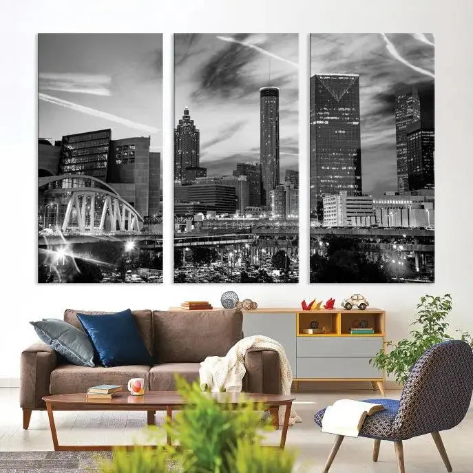 A modern living room featuring the Black and White Atlanta Wall Art Canvas Print as a triptych, displayed on museum-quality canvas and ready to hang.