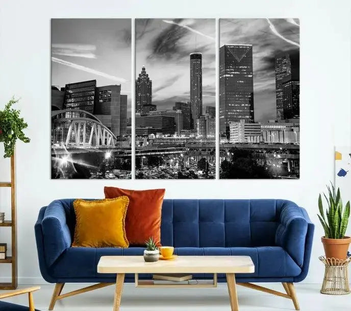 A modern living room featuring the Black and White Atlanta Wall Art Canvas Print as a triptych, displayed on museum-quality canvas and ready to hang.