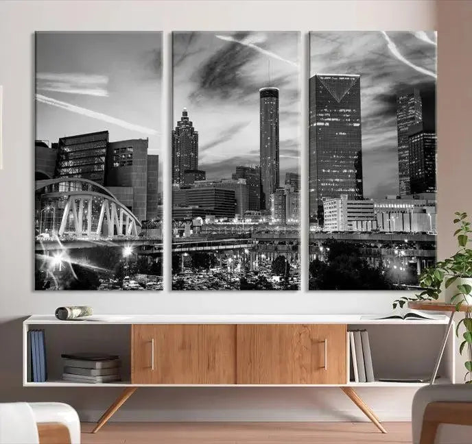 A modern living room featuring the Black and White Atlanta Wall Art Canvas Print as a triptych, displayed on museum-quality canvas and ready to hang.