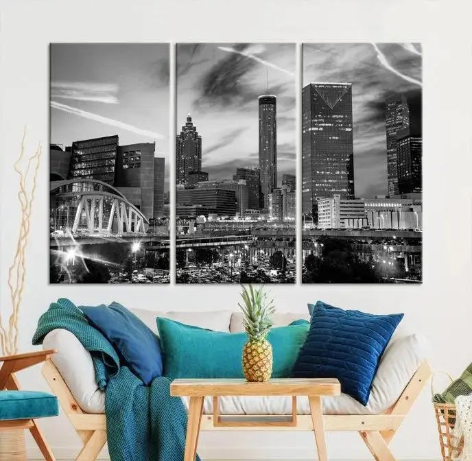 A modern living room featuring the Black and White Atlanta Wall Art Canvas Print as a triptych, displayed on museum-quality canvas and ready to hang.