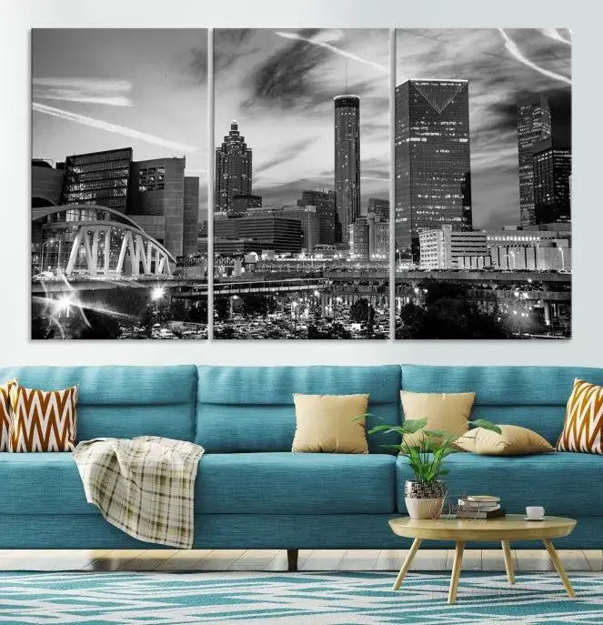 A modern living room featuring the Black and White Atlanta Wall Art Canvas Print as a triptych, displayed on museum-quality canvas and ready to hang.