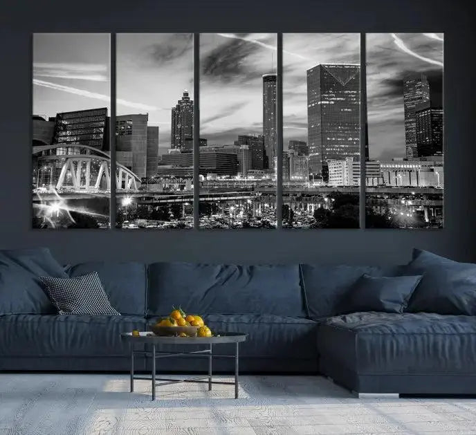 A modern living room featuring the Black and White Atlanta Wall Art Canvas Print as a triptych, displayed on museum-quality canvas and ready to hang.