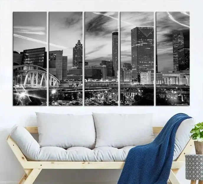 A modern living room featuring the Black and White Atlanta Wall Art Canvas Print as a triptych, displayed on museum-quality canvas and ready to hang.