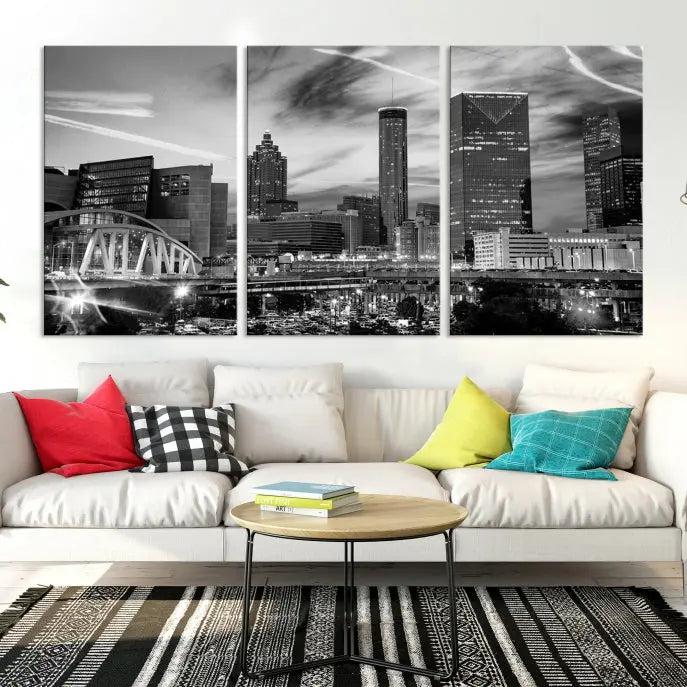 A modern living room featuring the Black and White Atlanta Wall Art Canvas Print as a triptych, displayed on museum-quality canvas and ready to hang.