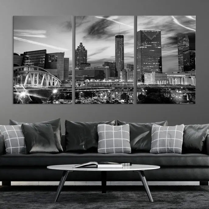 A modern living room featuring the Black and White Atlanta Wall Art Canvas Print as a triptych, displayed on museum-quality canvas and ready to hang.