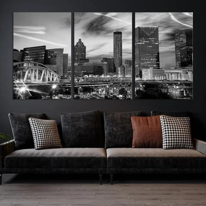 A modern living room featuring the Black and White Atlanta Wall Art Canvas Print as a triptych, displayed on museum-quality canvas and ready to hang.