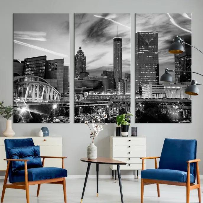 A modern living room featuring the Black and White Atlanta Wall Art Canvas Print as a triptych, displayed on museum-quality canvas and ready to hang.