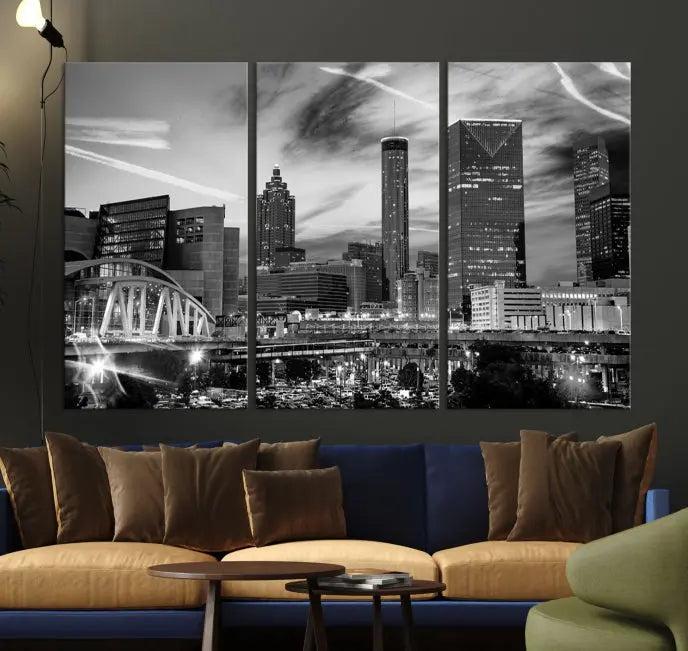 A modern living room featuring the Black and White Atlanta Wall Art Canvas Print as a triptych, displayed on museum-quality canvas and ready to hang.