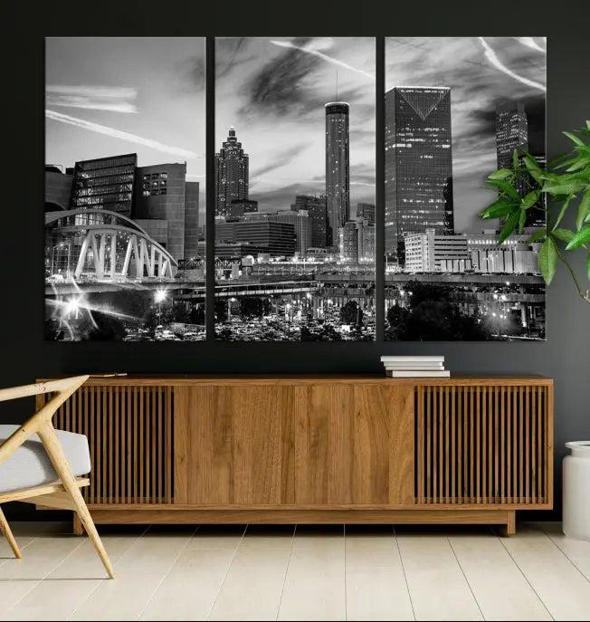 A modern living room featuring the Black and White Atlanta Wall Art Canvas Print as a triptych, displayed on museum-quality canvas and ready to hang.