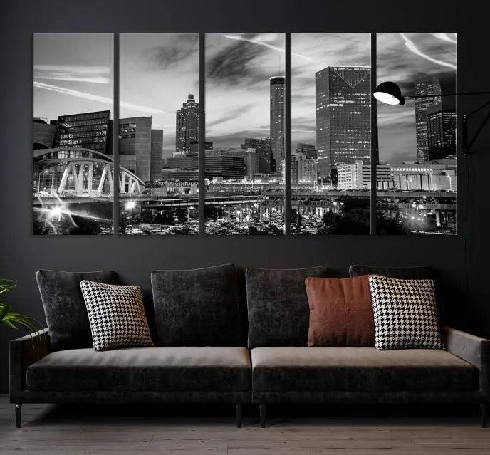 A modern living room featuring the Black and White Atlanta Wall Art Canvas Print as a triptych, displayed on museum-quality canvas and ready to hang.