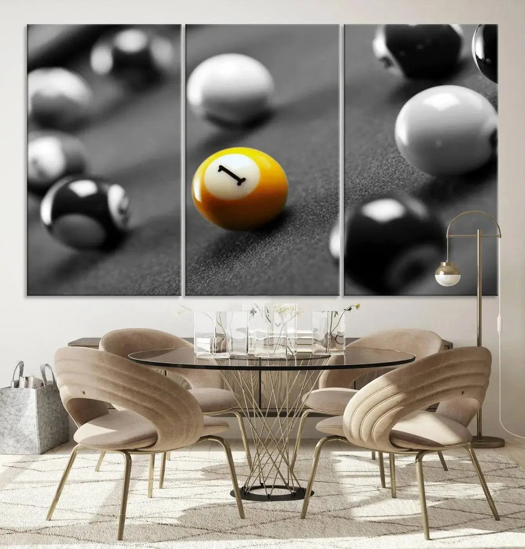 The modern living room features striking three-panel wall art titled "Black and White Concept Billiard Balls Canvas Print," showcasing a yellow number one ball on museum-quality canvas. This ready-to-hang piece is both stylish and convenient.