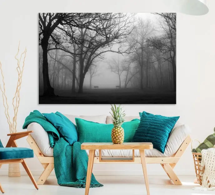 The wall displays the Black and White Foggy Forest Wall Art Canvas Print, carefully gallery wrapped and made from museum-quality pollycotton for an exquisite touch.