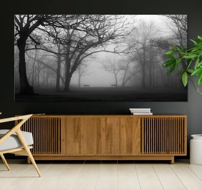 The wall displays the Black and White Foggy Forest Wall Art Canvas Print, carefully gallery wrapped and made from museum-quality pollycotton for an exquisite touch.