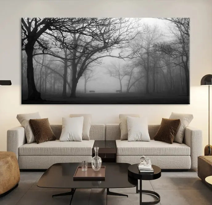 The wall displays the Black and White Foggy Forest Wall Art Canvas Print, carefully gallery wrapped and made from museum-quality pollycotton for an exquisite touch.