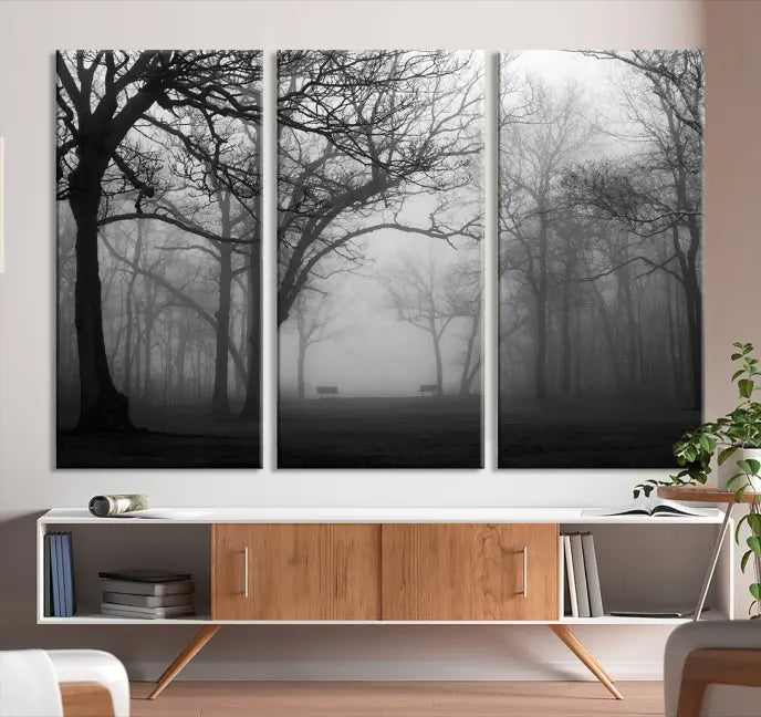 The wall displays the Black and White Foggy Forest Wall Art Canvas Print, carefully gallery wrapped and made from museum-quality pollycotton for an exquisite touch.