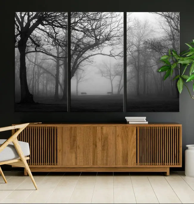 The wall displays the Black and White Foggy Forest Wall Art Canvas Print, carefully gallery wrapped and made from museum-quality pollycotton for an exquisite touch.