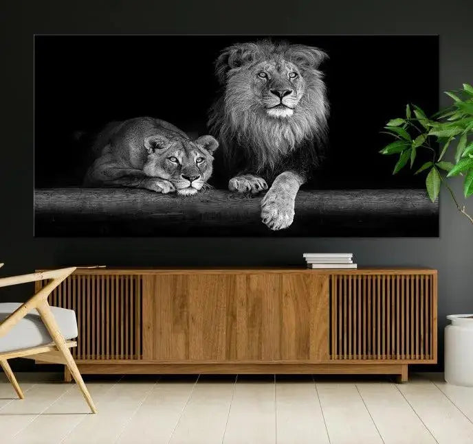 A triptych of the Black and White Lion Couple Wall Art Canvas Print hangs elegantly, showcasing museum-quality, hand-assembled framed art pieces. Enjoy free shipping on this stunning artwork.