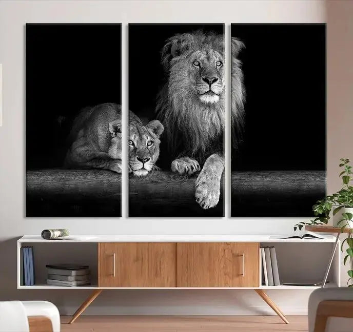 A triptych of the Black and White Lion Couple Wall Art Canvas Print hangs elegantly, showcasing museum-quality, hand-assembled framed art pieces. Enjoy free shipping on this stunning artwork.