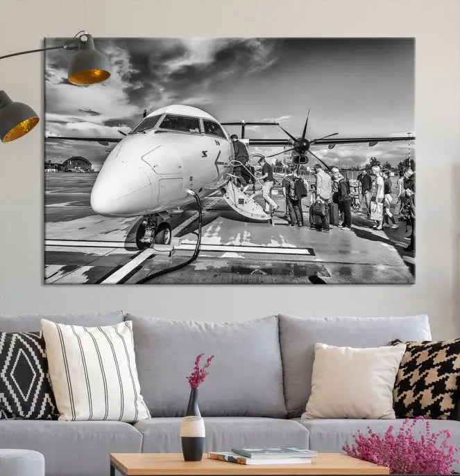 Introducing the Black and White Narrow Body Aircraft Wall Art Canvas Print: This striking three-panel canvas features a timeless black-and-white depiction of people boarding a propeller airplane. Printed on museum-quality canvas, each piece is UV-protected to maintain its vibrancy. These prints are ready to hang, making it easy to display them with ease.