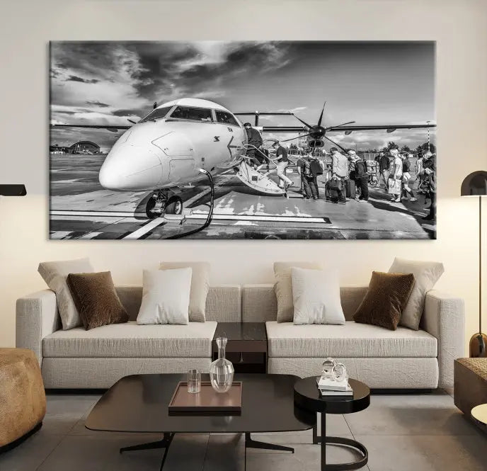 Introducing the Black and White Narrow Body Aircraft Wall Art Canvas Print: This striking three-panel canvas features a timeless black-and-white depiction of people boarding a propeller airplane. Printed on museum-quality canvas, each piece is UV-protected to maintain its vibrancy. These prints are ready to hang, making it easy to display them with ease.