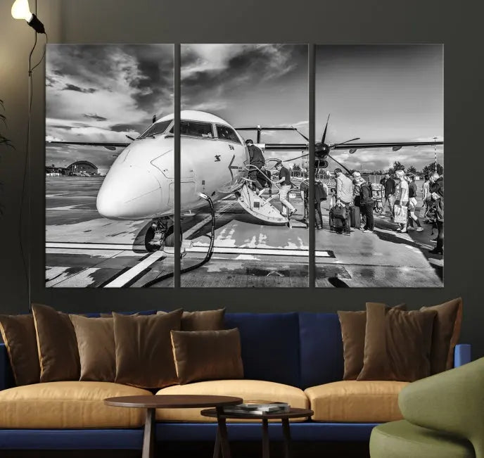 Introducing the Black and White Narrow Body Aircraft Wall Art Canvas Print: This striking three-panel canvas features a timeless black-and-white depiction of people boarding a propeller airplane. Printed on museum-quality canvas, each piece is UV-protected to maintain its vibrancy. These prints are ready to hang, making it easy to display them with ease.