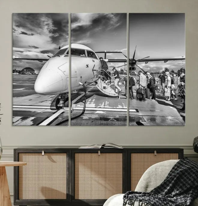 Introducing the Black and White Narrow Body Aircraft Wall Art Canvas Print: This striking three-panel canvas features a timeless black-and-white depiction of people boarding a propeller airplane. Printed on museum-quality canvas, each piece is UV-protected to maintain its vibrancy. These prints are ready to hang, making it easy to display them with ease.