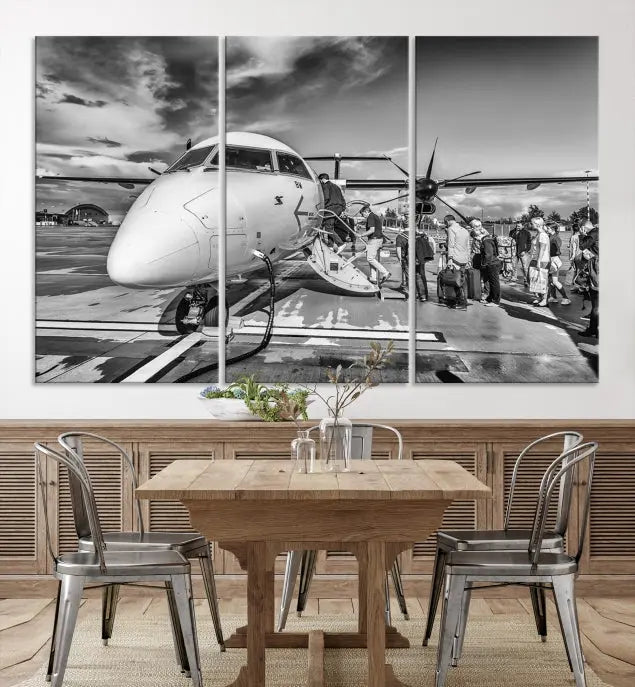 Introducing the Black and White Narrow Body Aircraft Wall Art Canvas Print: This striking three-panel canvas features a timeless black-and-white depiction of people boarding a propeller airplane. Printed on museum-quality canvas, each piece is UV-protected to maintain its vibrancy. These prints are ready to hang, making it easy to display them with ease.