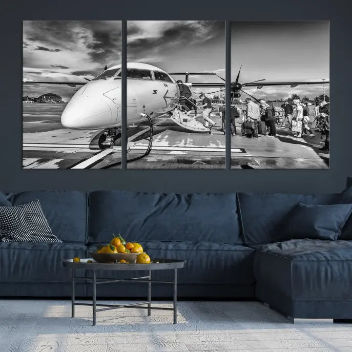 Introducing the Black and White Narrow Body Aircraft Wall Art Canvas Print: This striking three-panel canvas features a timeless black-and-white depiction of people boarding a propeller airplane. Printed on museum-quality canvas, each piece is UV-protected to maintain its vibrancy. These prints are ready to hang, making it easy to display them with ease.