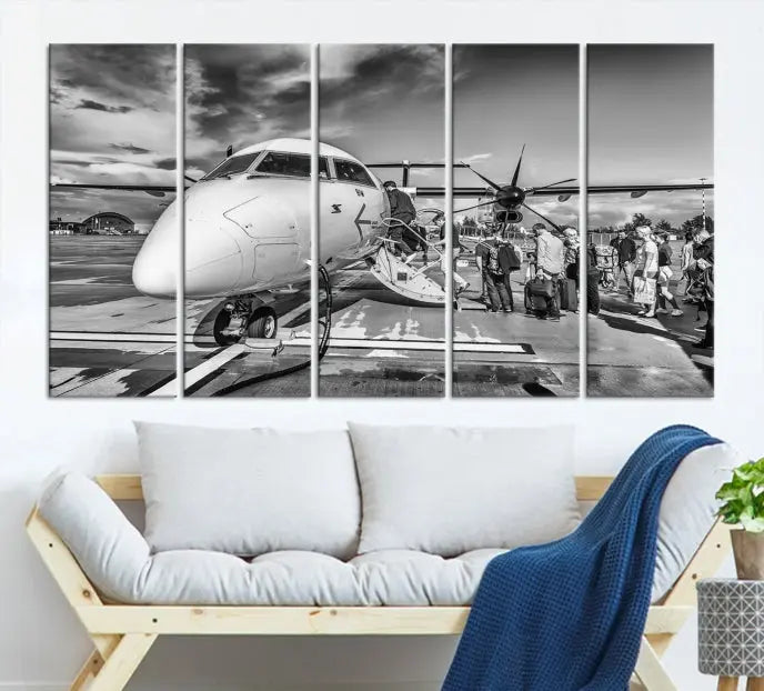 Introducing the Black and White Narrow Body Aircraft Wall Art Canvas Print: This striking three-panel canvas features a timeless black-and-white depiction of people boarding a propeller airplane. Printed on museum-quality canvas, each piece is UV-protected to maintain its vibrancy. These prints are ready to hang, making it easy to display them with ease.