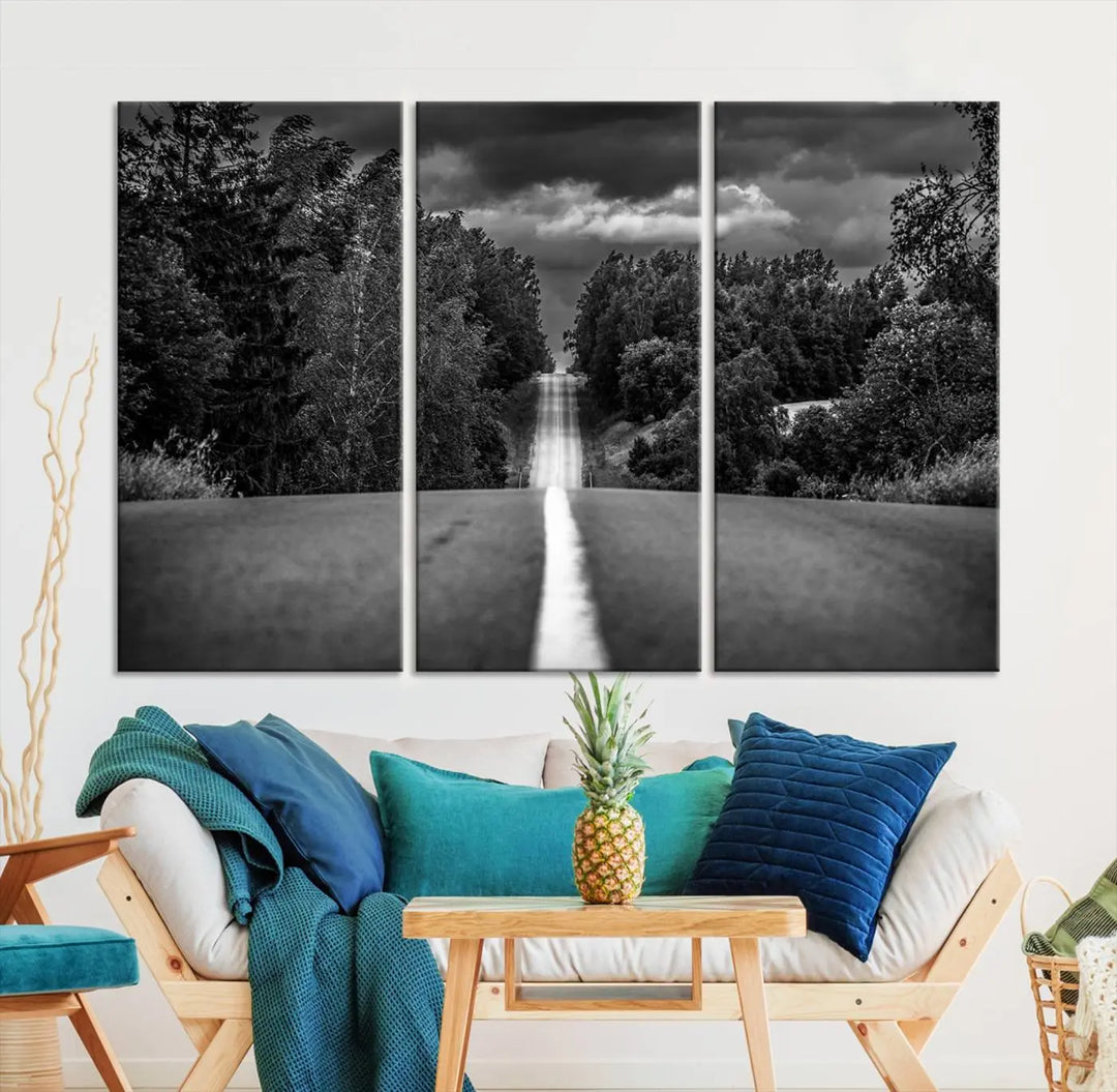 The Black and White Road in Forest Wall Art Canvas Print captures a rural road disappearing into the distance under cloudy skies, presented as a triptych. These gallery-wrapped canvases boast museum-quality construction and a UV-protective coating.