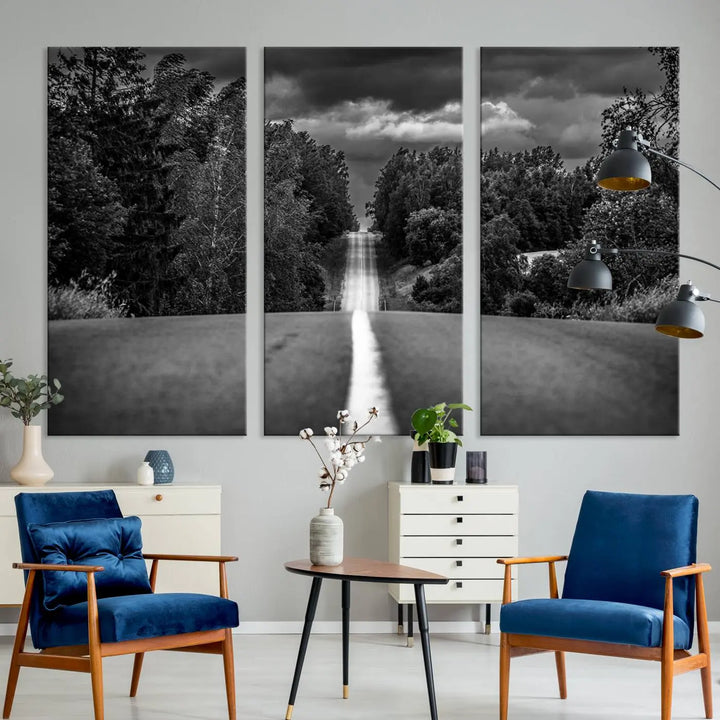 The Black and White Road in Forest Wall Art Canvas Print captures a rural road disappearing into the distance under cloudy skies, presented as a triptych. These gallery-wrapped canvases boast museum-quality construction and a UV-protective coating.