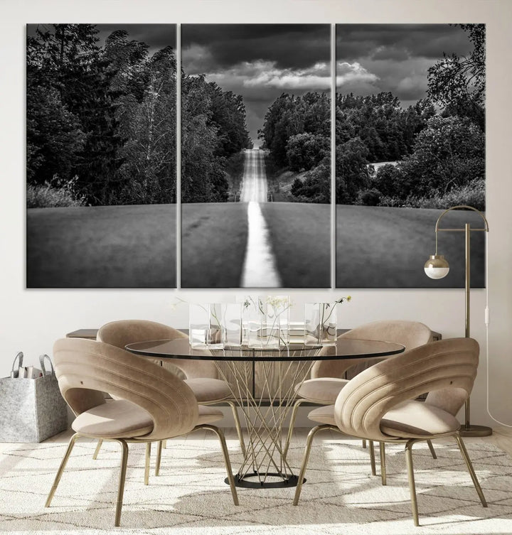 The Black and White Road in Forest Wall Art Canvas Print captures a rural road disappearing into the distance under cloudy skies, presented as a triptych. These gallery-wrapped canvases boast museum-quality construction and a UV-protective coating.