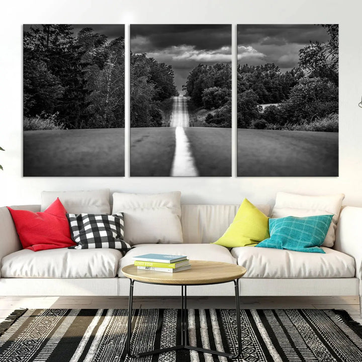 The Black and White Road in Forest Wall Art Canvas Print captures a rural road disappearing into the distance under cloudy skies, presented as a triptych. These gallery-wrapped canvases boast museum-quality construction and a UV-protective coating.