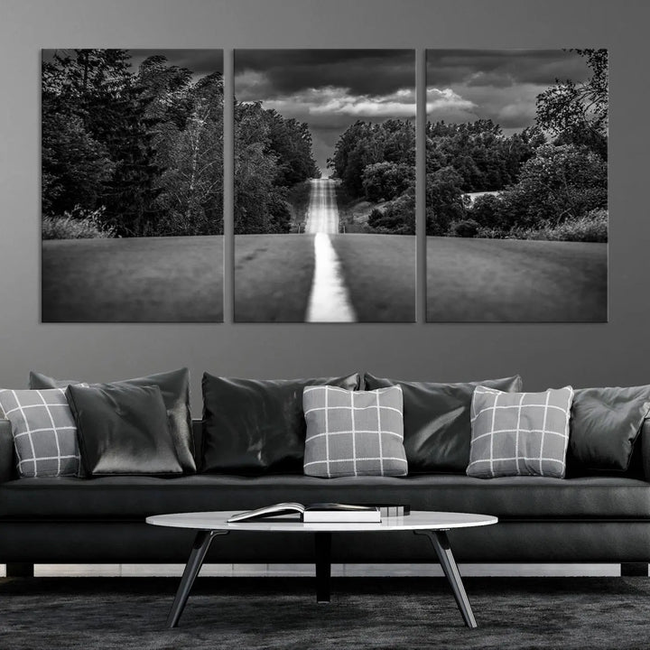 The Black and White Road in Forest Wall Art Canvas Print captures a rural road disappearing into the distance under cloudy skies, presented as a triptych. These gallery-wrapped canvases boast museum-quality construction and a UV-protective coating.