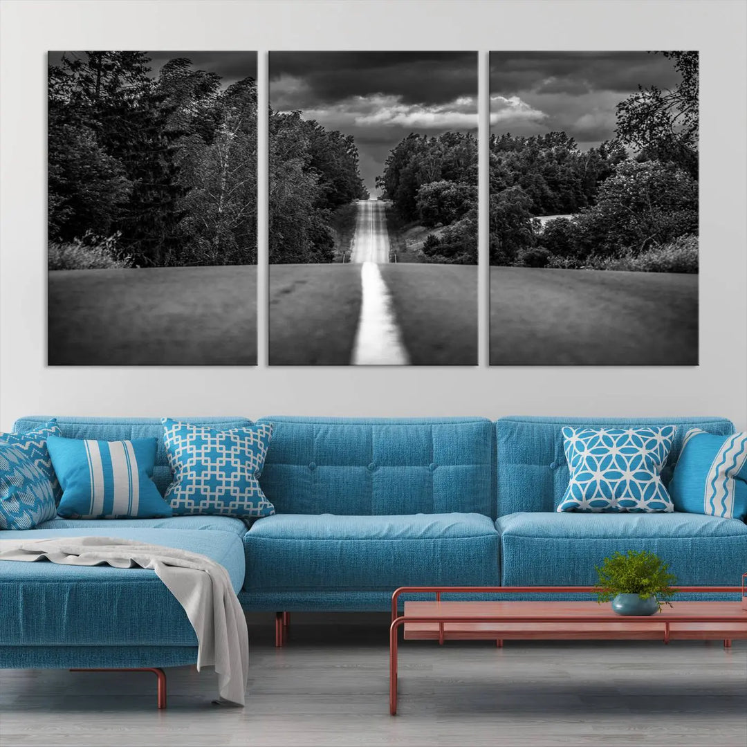 The Black and White Road in Forest Wall Art Canvas Print captures a rural road disappearing into the distance under cloudy skies, presented as a triptych. These gallery-wrapped canvases boast museum-quality construction and a UV-protective coating.