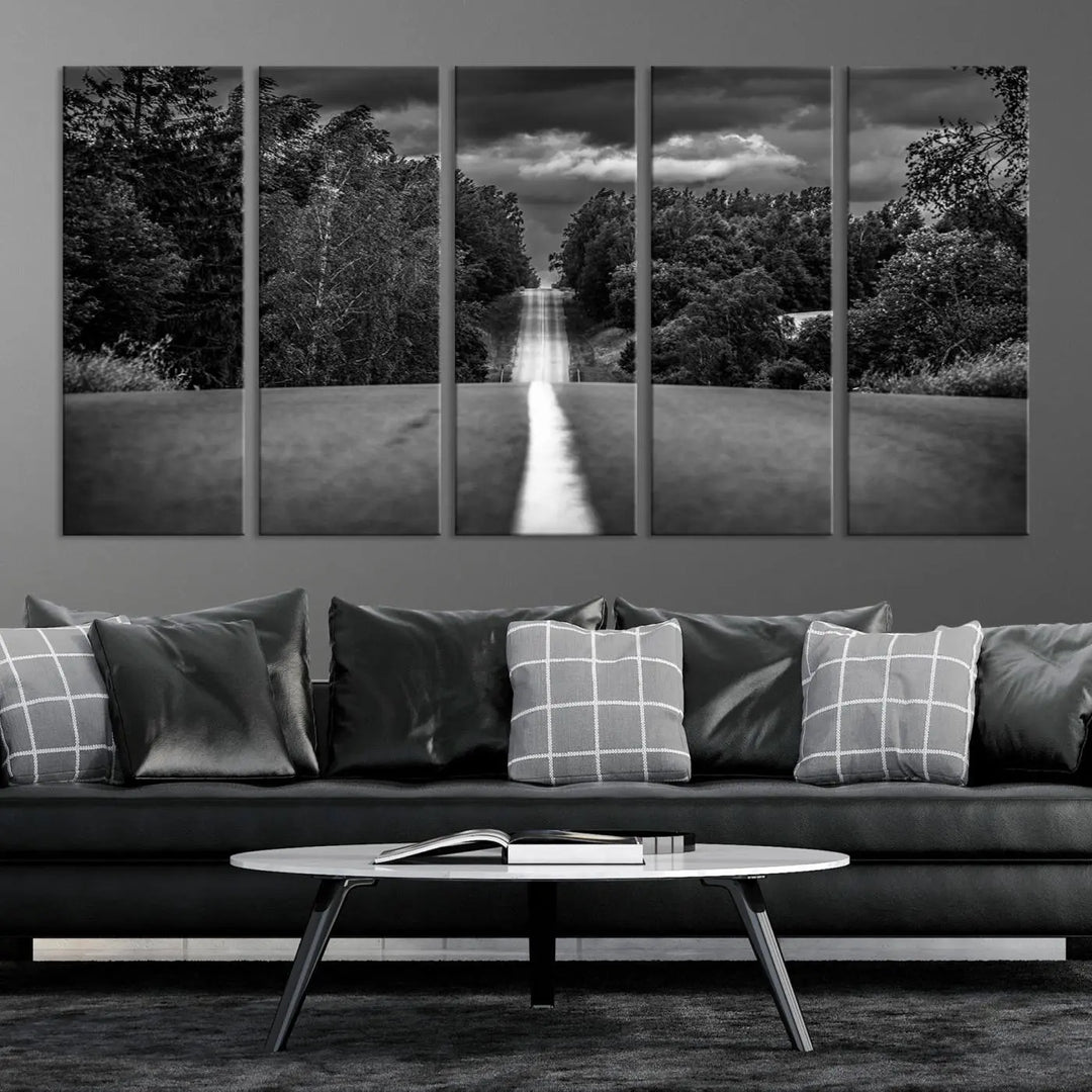 The Black and White Road in Forest Wall Art Canvas Print captures a rural road disappearing into the distance under cloudy skies, presented as a triptych. These gallery-wrapped canvases boast museum-quality construction and a UV-protective coating.