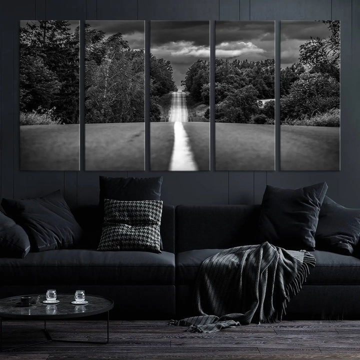 The Black and White Road in Forest Wall Art Canvas Print captures a rural road disappearing into the distance under cloudy skies, presented as a triptych. These gallery-wrapped canvases boast museum-quality construction and a UV-protective coating.