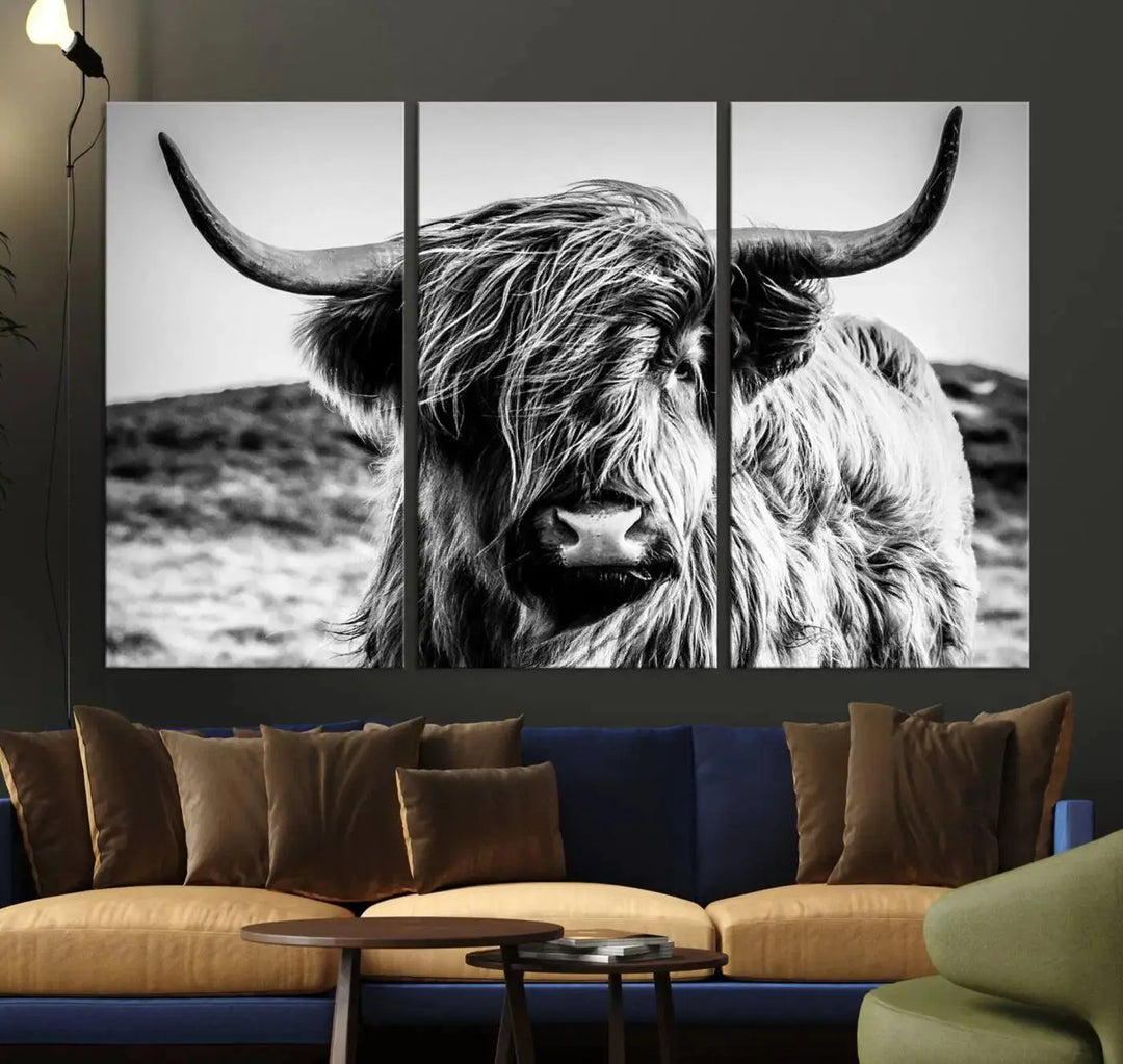 The "Black and White Scottish Cow Canvas Wall Art," a three-panel piece featuring a long-haired cow with large horns, enhances the room with its farmhouse decor charm.