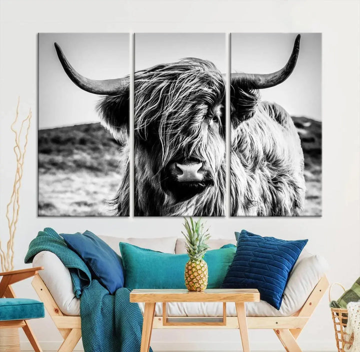 The "Black and White Scottish Cow Canvas Wall Art," a three-panel piece featuring a long-haired cow with large horns, enhances the room with its farmhouse decor charm.