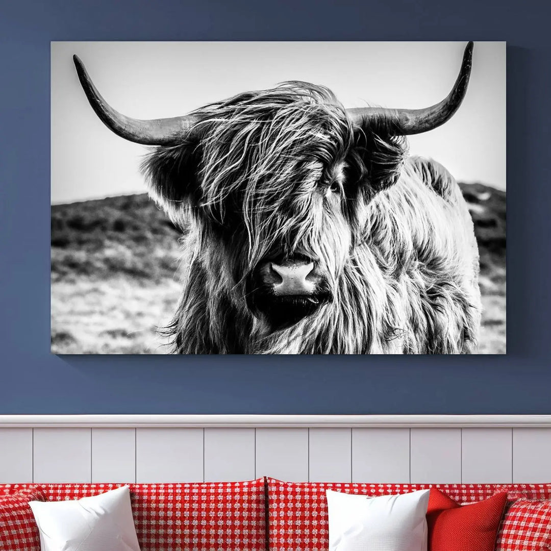 The "Black and White Scottish Cow Canvas Wall Art," a three-panel piece featuring a long-haired cow with large horns, enhances the room with its farmhouse decor charm.