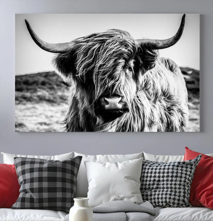 The "Black and White Scottish Cow Canvas Wall Art," a three-panel piece featuring a long-haired cow with large horns, enhances the room with its farmhouse decor charm.