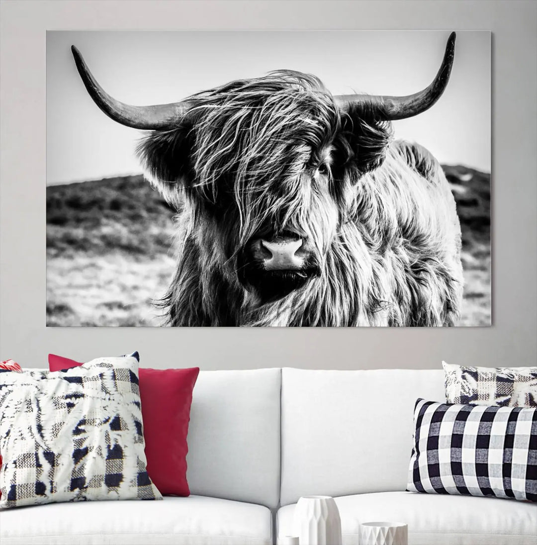 The "Black and White Scottish Cow Canvas Wall Art," a three-panel piece featuring a long-haired cow with large horns, enhances the room with its farmhouse decor charm.