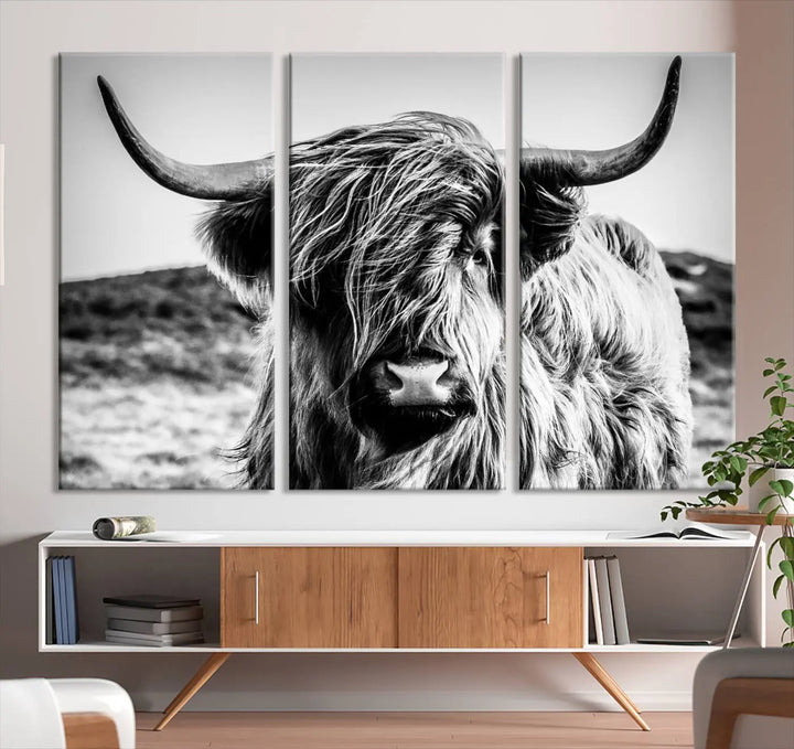 The "Black and White Scottish Cow Canvas Wall Art," a three-panel piece featuring a long-haired cow with large horns, enhances the room with its farmhouse decor charm.