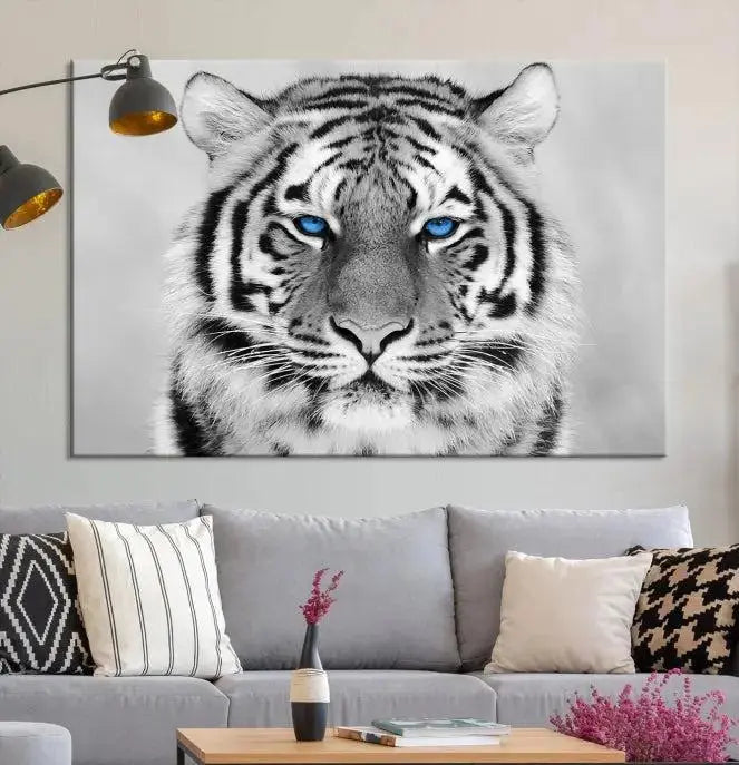 A piece from the Black and White Tiger Wall Art Animal Canvas Print collection, showcasing a white tiger with blue eyes on premium canvas, is displayed.