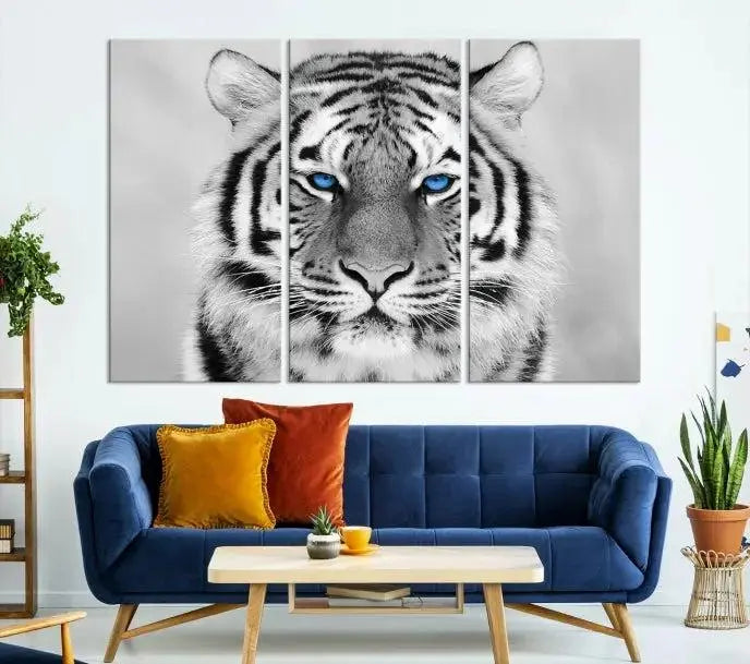 A piece from the Black and White Tiger Wall Art Animal Canvas Print collection, showcasing a white tiger with blue eyes on premium canvas, is displayed.