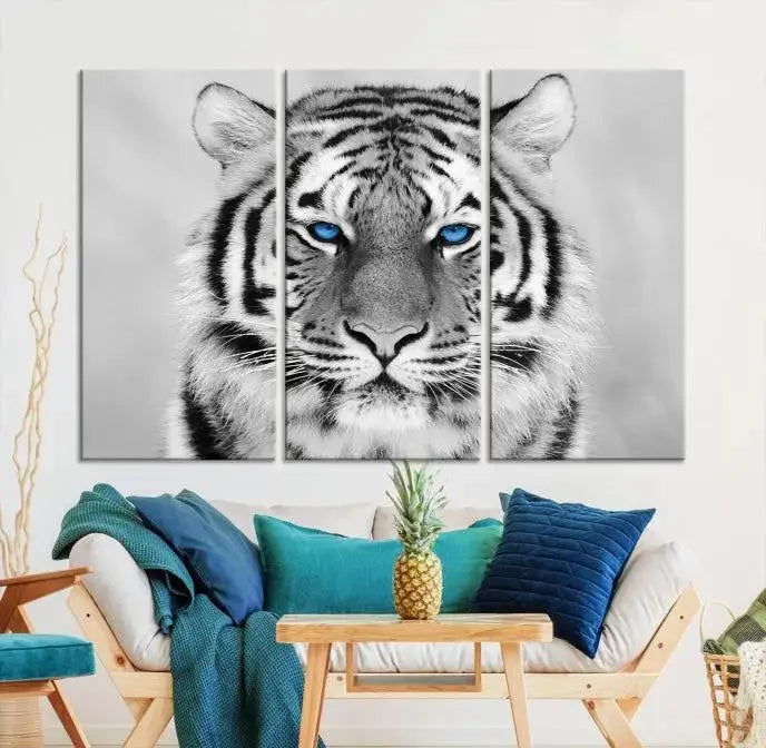 A piece from the Black and White Tiger Wall Art Animal Canvas Print collection, showcasing a white tiger with blue eyes on premium canvas, is displayed.