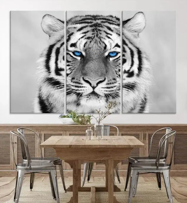 A piece from the Black and White Tiger Wall Art Animal Canvas Print collection, showcasing a white tiger with blue eyes on premium canvas, is displayed.