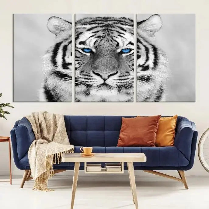 A piece from the Black and White Tiger Wall Art Animal Canvas Print collection, showcasing a white tiger with blue eyes on premium canvas, is displayed.